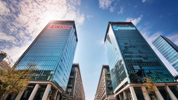 Two tower blocks stand centre, reflecting the impact of the upcoming election on UK property law.
