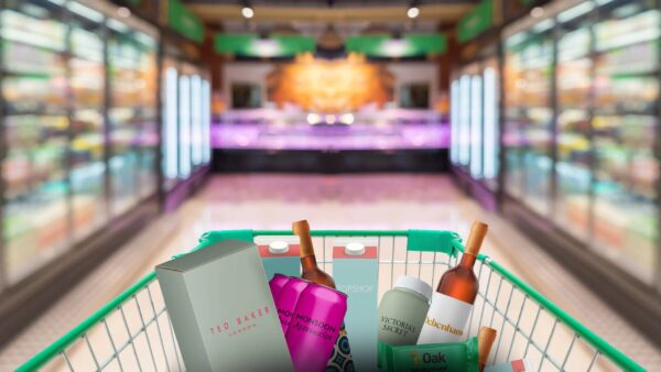 A supermarket can be seen. In the centre, a shopping trolley holding items branded by businesses that have gone into administration.