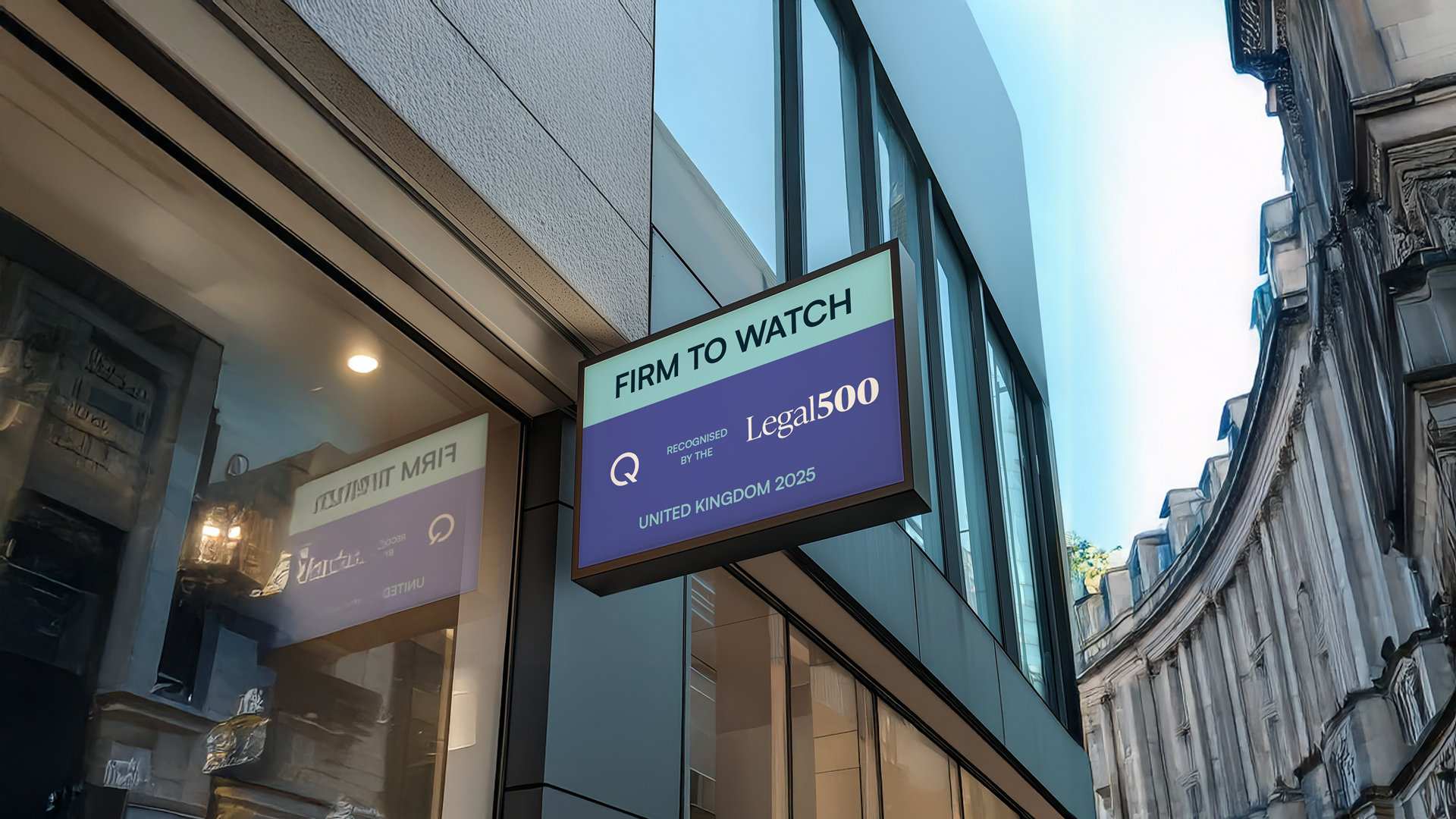 Shop signage in Oxford Street, The Sign says firm to watch in the legal 500 for Quastels