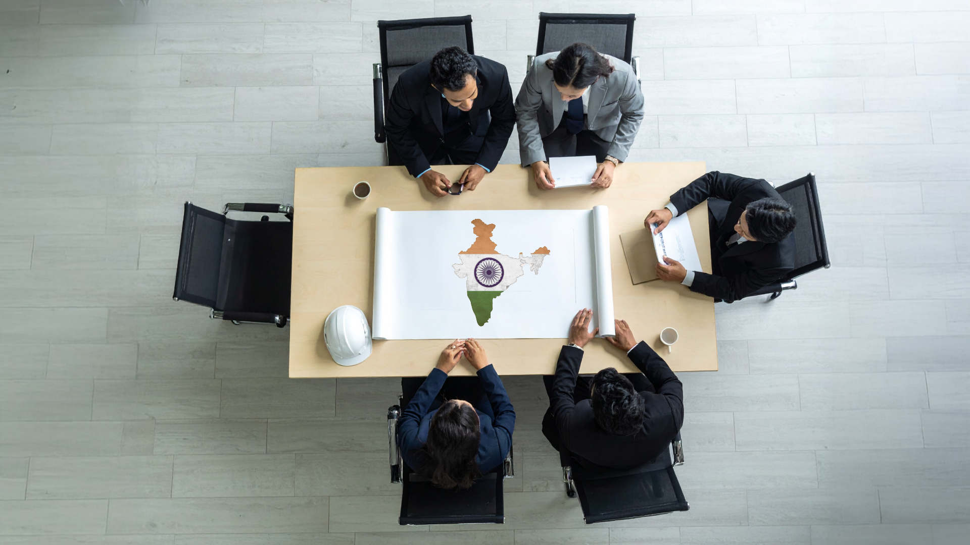 A brand board sit over a map of India, discussing expansion.