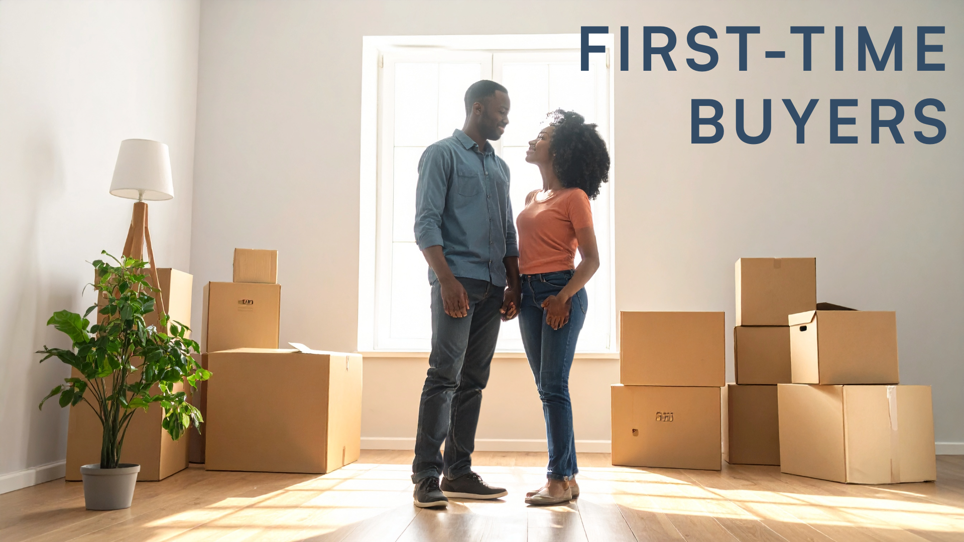A couple who have just purchased their first property together as first time buyers, stand together in their new home.