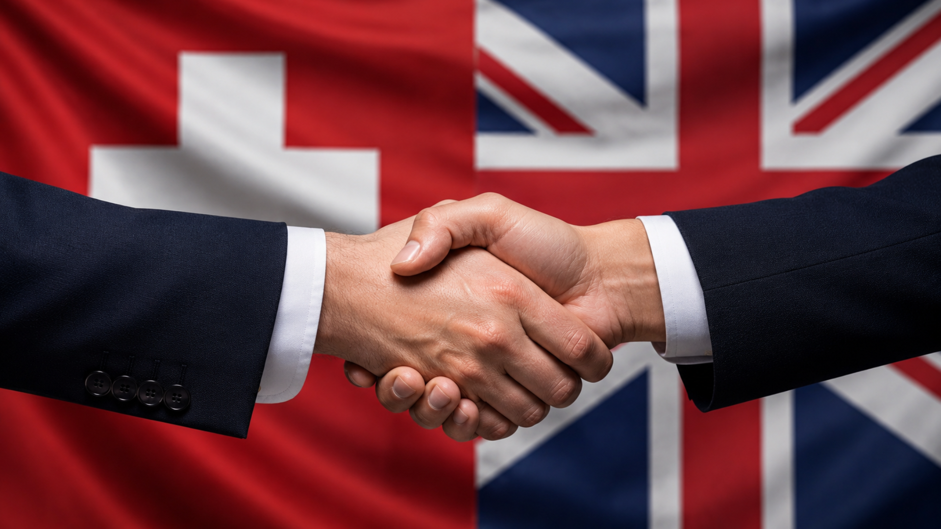 Hands shaking in front of Swiss flag and Union Jack, to represent the UK-Switzerland trade agreement.